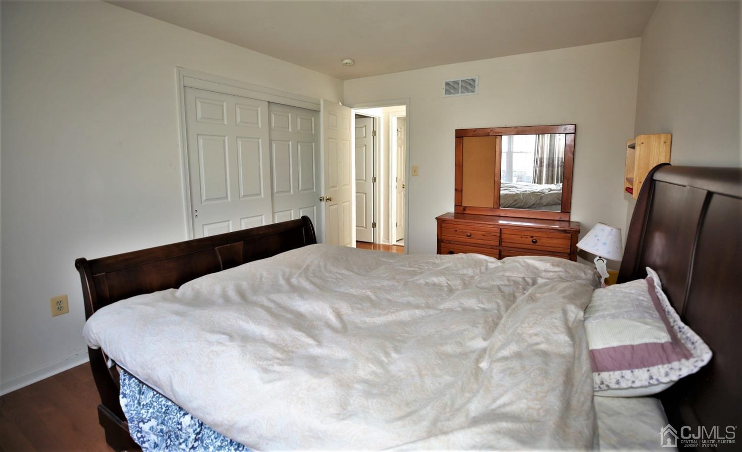28 Lexington Road Monmouth Junction, NJ 08852 - Photo 37 of 55 a bedroom with a bed and dresser with mirror