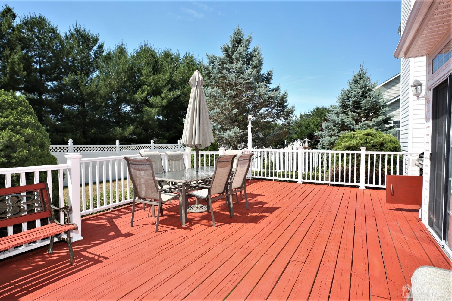 28 Lexington Road Monmouth Junction, NJ 08852 - Photo 50 of 55 a view of a deck with chairs a barbeque with wooden floor and fence