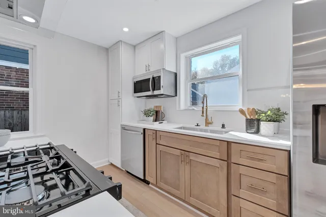 a kitchen with a sink stove and microwave