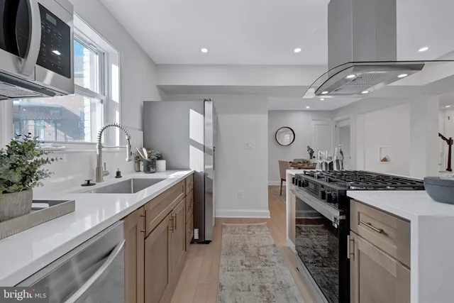 a kitchen with sink stove and cabinets
