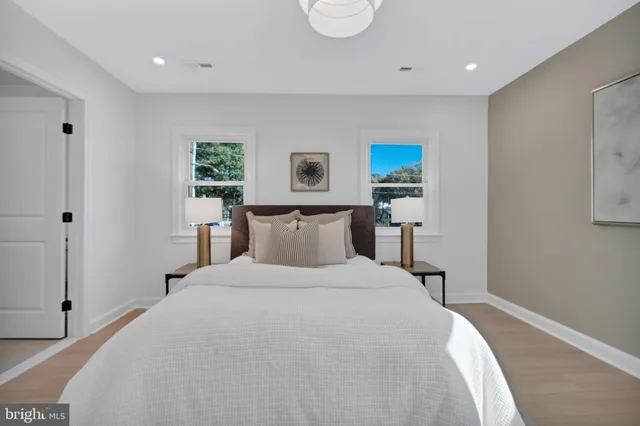 a bedroom with a bed and a painting