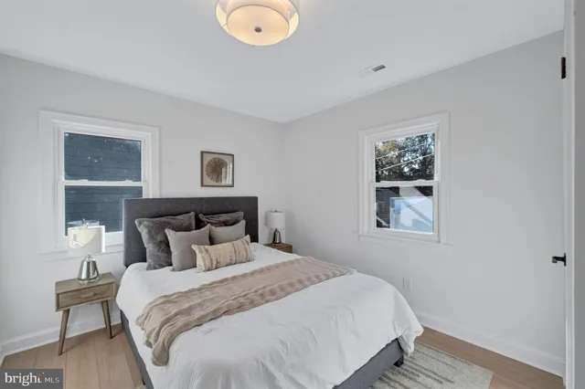 a bedroom with a bed and painting on the wall