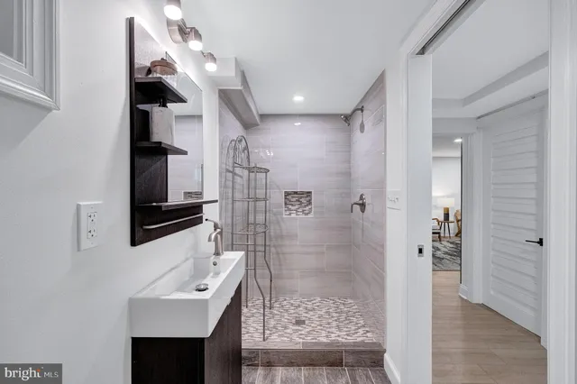 a bathroom with a sink a toilet and shower