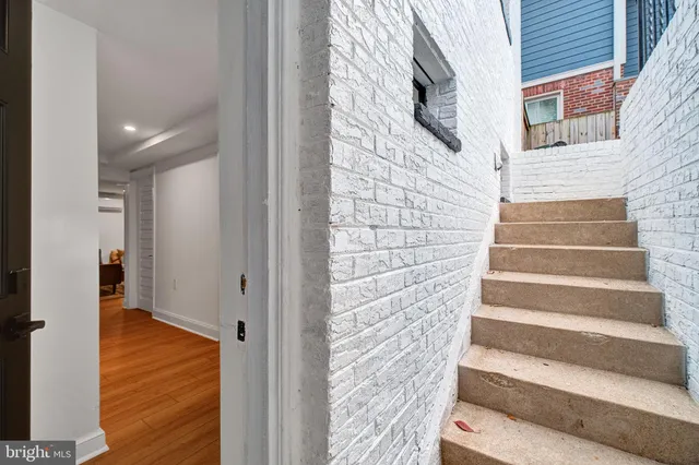 a view of entryway with wooden floor and stairs