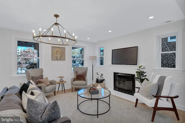 a living room with furniture a fireplace and a flat screen tv