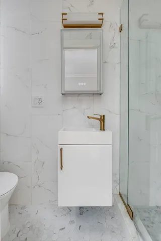 a bathroom with a sink a mirror and shower