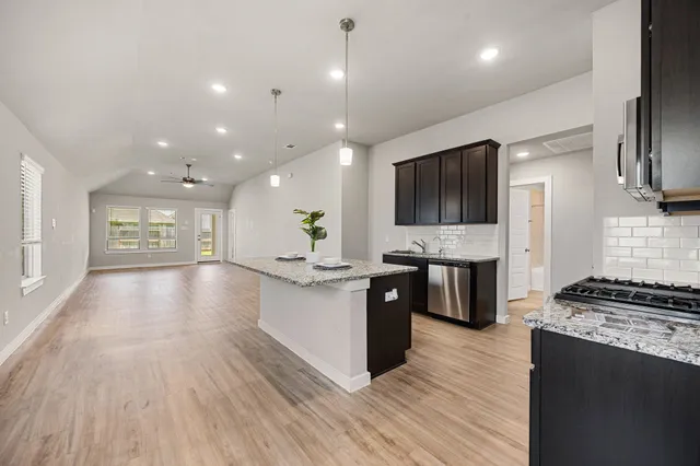 a view of kitchen with sink microwave and refrigerator