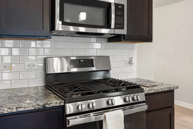a stove top oven sitting inside of a kitchen
