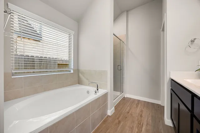 a bathroom with a bathtub and a shower