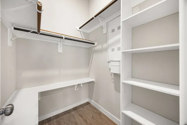 a view of walk in closet with empty racks