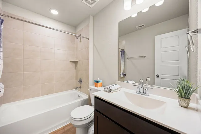 a bathroom with a sink a toilet and a bathtub