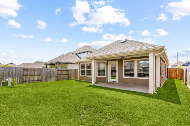 a view of a house with a yard and sitting area