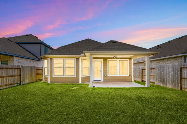 a front view of a house with a garden and yard