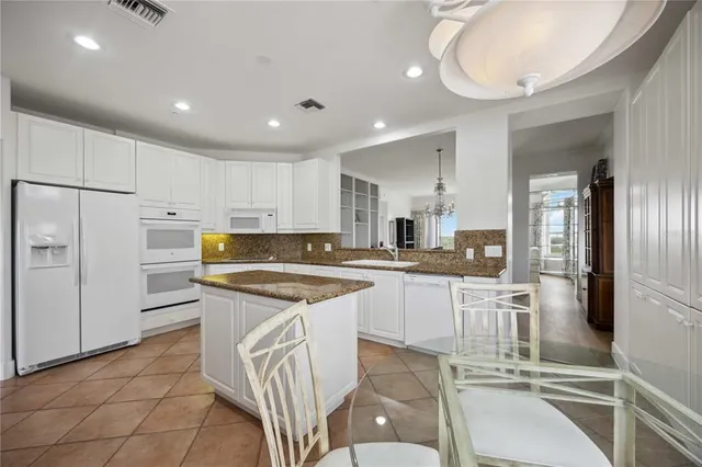 a kitchen with stainless steel appliances granite countertop a sink and cabinets