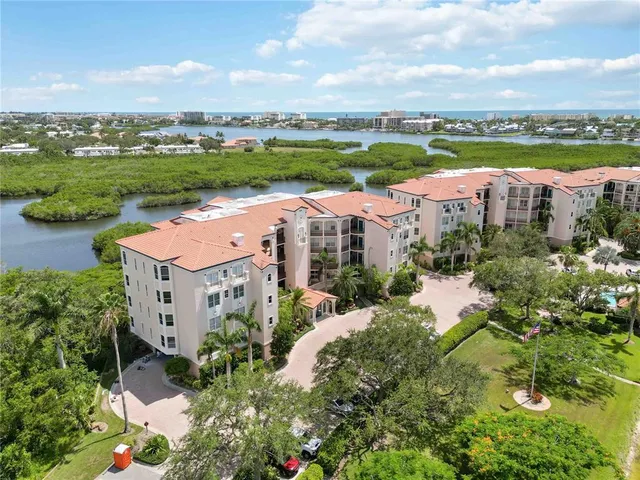 an aerial view of a house with a garden and lake view
