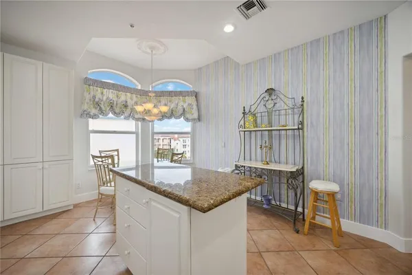 a kitchen with a table chairs and a chandelier