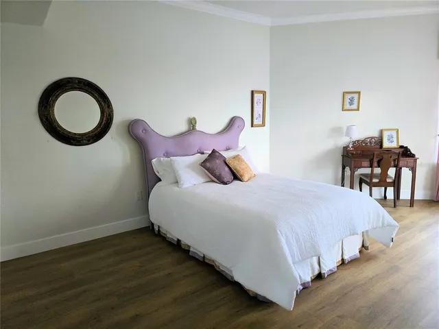 a bedroom with a bed and dresser