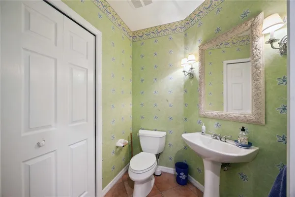 a bathroom with a sink and mirror with toilet