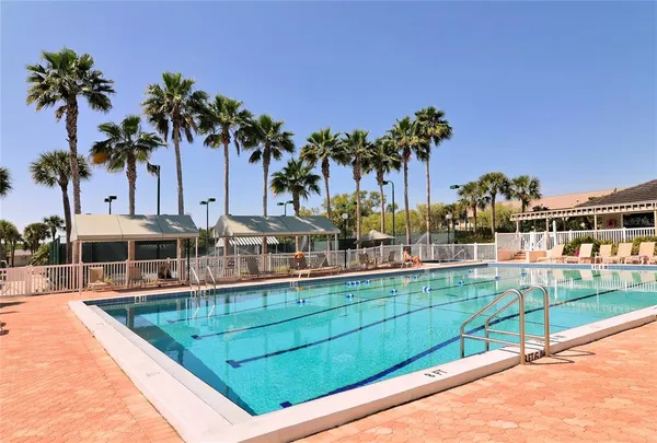 a view of a house with a swimming pool and sitting area