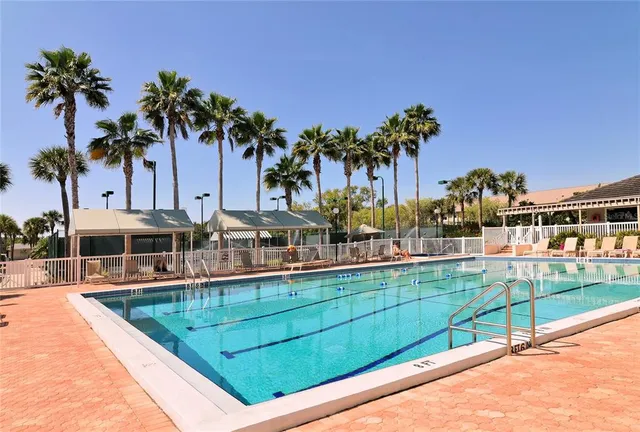 a view of a house with a swimming pool and sitting area