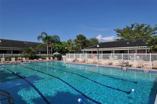 a view of a house with swimming pool and yard