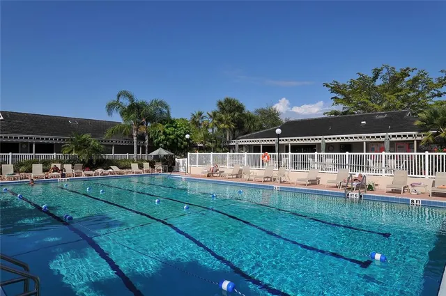 a view of a house with swimming pool and yard