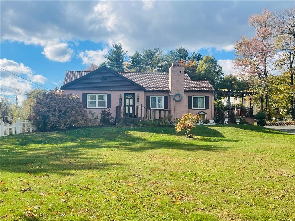 16 Coates Avenue New Castle, PA 16101 - Photo 1 of 23 a front view of a house with a yard table and chairs