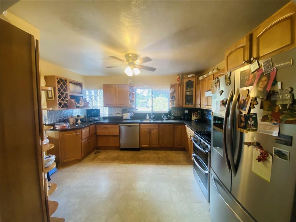 16 Coates Avenue New Castle, PA 16101 - Photo 12 of 23 a large kitchen with cabinets and stainless steel appliances