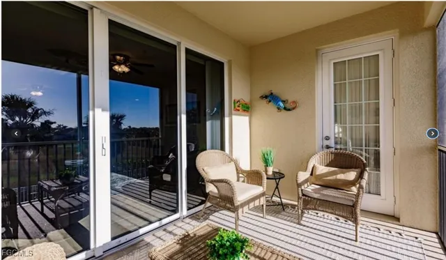 a living room with furniture and potted plants