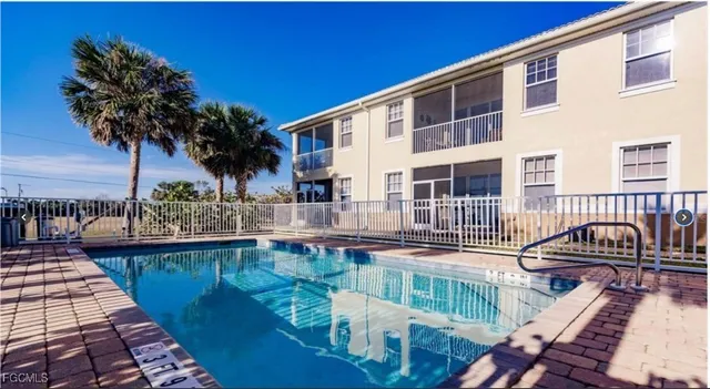 a swimming pool with outdoor seating and yard