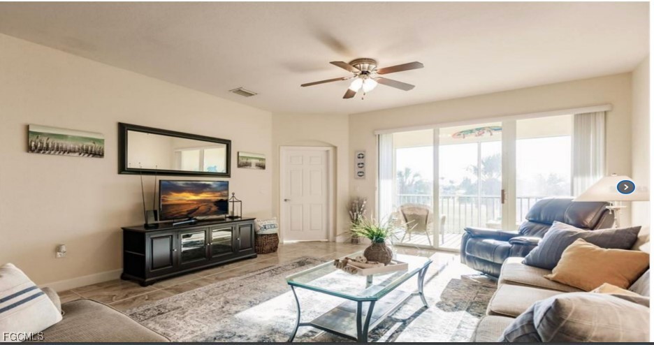 16572 San Edmundo Road, Unit 122 Punta Gorda, FL 33955 - Photo 5 of 23 a living room with furniture a flat screen tv and a large window