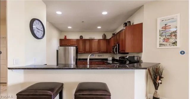 a kitchen with cabinets and chairs