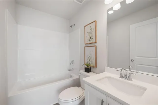 a bathroom with a sink a toilet and bathtub