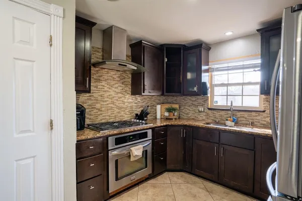 a kitchen with a sink stove and cabinets