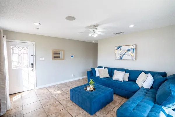 a living room with furniture and wooden floor