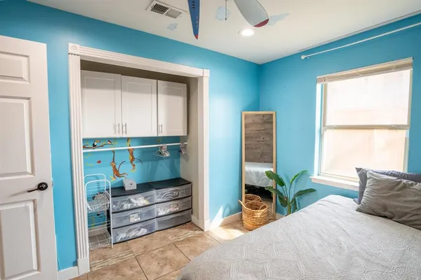 a bedroom with furniture and a window