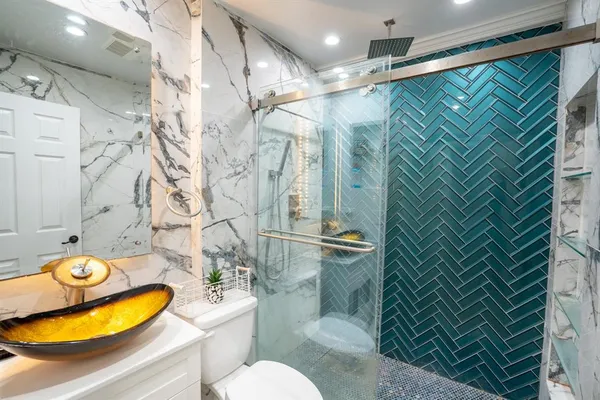 a bathroom with a sink toilet and shower