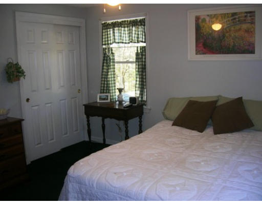 45 Brooks Village Road Phillipston, MA 01331 - Photo 10 of 12 a bedroom with a bed and a table