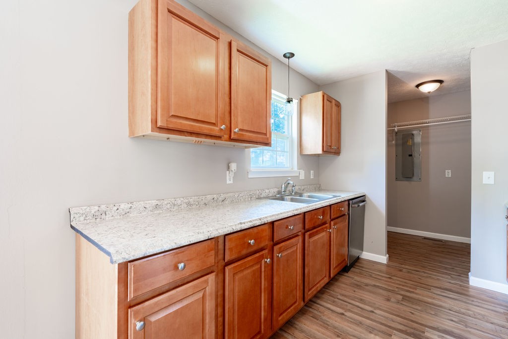 122 Cora Street Portland, TN 37148 - Photo 15 of 28 a kitchen with a sink cabinets and wooden floor