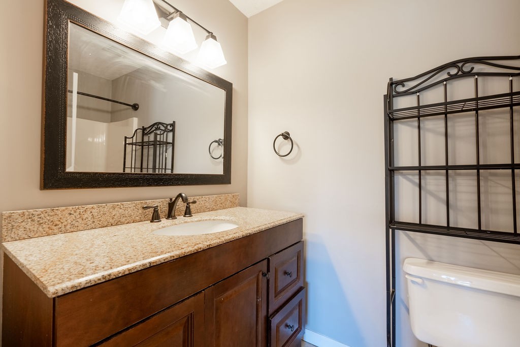 122 Cora Street Portland, TN 37148 - Photo 19 of 28 a bathroom with a granite countertop sink and a mirror