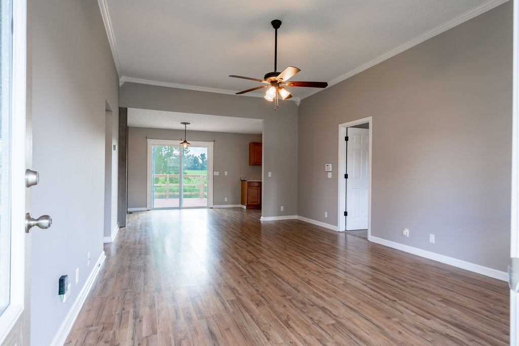122 Cora Street Portland, TN 37148 - Photo 20 of 28 a view of a livingroom with a hardwood floor and a ceiling fan