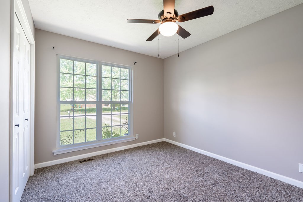 122 Cora Street Portland, TN 37148 - Photo 23 of 28 an empty room with a window and a fan