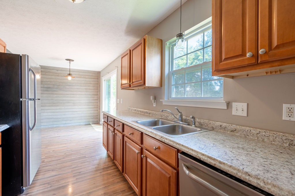 122 Cora Street Portland, TN 37148 - Photo 26 of 28 a kitchen with granite countertop stainless steel appliances a sink window and cabinets