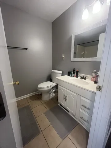 a bathroom with a sink toilet and mirror