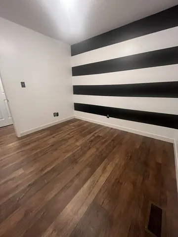 a view of room with wooden floor