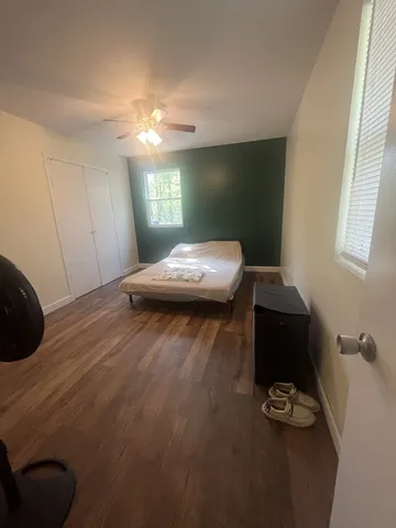 a bedroom with a bed and a window