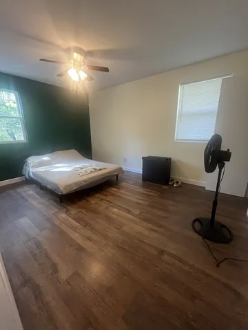 a living room with furniture and a lamp