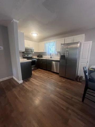 a kitchen with a refrigerator and a sink