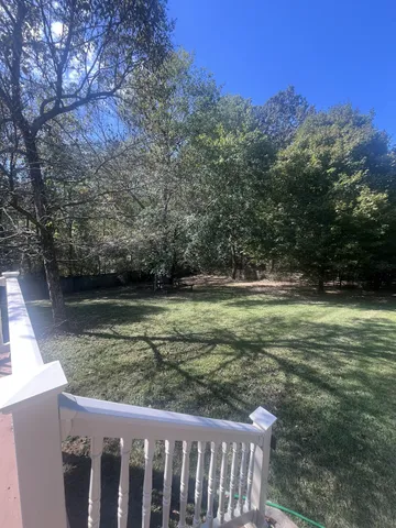 a view of outdoor space with deck and yard