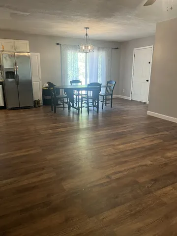 a view of dining room with furniture and wooden floor